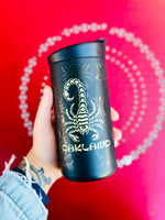 Timeless Coffee Roasters Black Oakland Scorpion To-Go Tumbler with Gold Scorpion on a Red Background